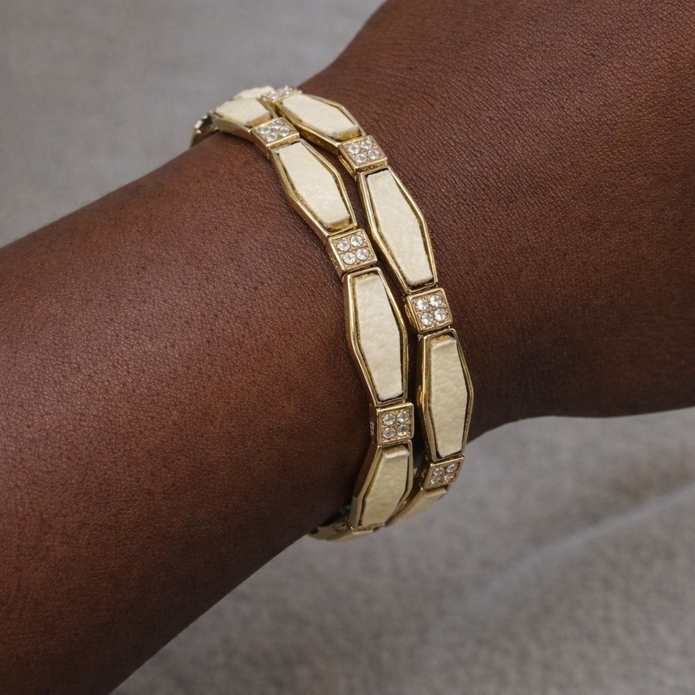 GOLD TONE CREAM  BRACLETES WITH CHRYSTAL ACCENTS.